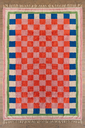 Green, blue, pink and red chequered tufted rug